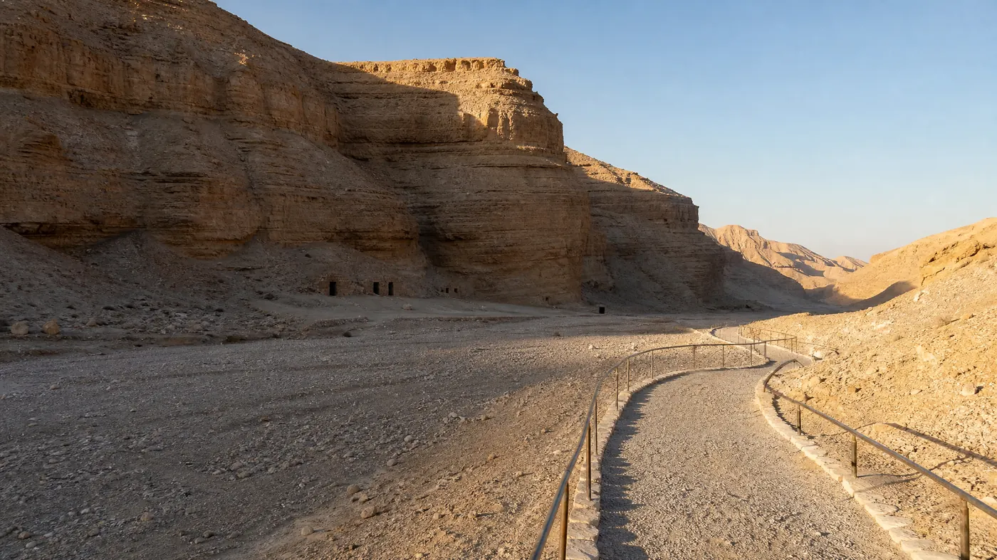 The valley itself: a made path with handrails between bare limestone slopes, which is what the walk between one tomb entrance and the next actually looks like